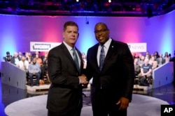 Boston Mayor Marty Walsh, left, and City Councilor Tito Jackson, right, greet one another after a mayoral debate at the WGBH Studios in Boston, Tuesday, Oct. 24, 2017.