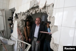 FILE - Resident Coordinator of the United Nations in Yemen, Jamie McGoldrick, inspects damage at a hospital in Yemen's southwestern city of Taiz, Jan. 21, 2016.