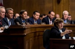 Phoenix prosecutor Rachel Mitchell questions Christine Blasey Ford as, from left, Sen. Mike Crapo, R-Idaho, Sen. Jeff Flake, R-Ariz., Sen. Ben Sasse, R-Neb., Sen. Ted Cruz, R-Texas, Sen. Mike Lee, R-Utah, and Sen. John Cornyn, R-Texas, listen during a Senate Judiciary Committee hearing, Sept. 27, 2018 on Capitol Hill in Washington.