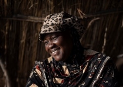 Fatou Samba, president of the association of female fish processors, poses in a makeshift tent at the processing site in Bargny, Senegal, Apr. 25, 2021.