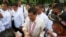 Philippine President Rodrigo Duterte poses is greeted by supporters following a wreath-laying ceremony in observance of National Heroes Day Monday, Aug. 29, 2016 at the Heroes Cemetery in suburban Taguig city east of Manila, Philippines. 