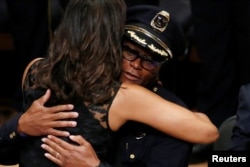 U.S. First Lady Michelle Obama hugs Dallas police chief David Brown at a memorial service following the multiple police shootings in Dallas, Texas, U.S., July 12, 2016.