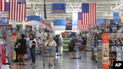 FILE - Customers shop at a Wal-Mart Supercenter store in Springdale, Arkansas.