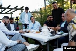 Guests from places within Denmark and Northern Europe sit together at the engagement party of a resident in Mjolnerparken, a housing estate on the Danish government's "Ghetto List," in Copenhagen, Denmark, May 6, 2018.