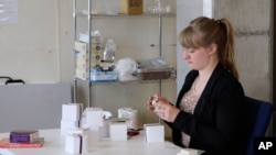 Allene Swanson, 22, prepares packages of saffron grown by Afghan farmers for distribution, at her workplace in Chicago, April 21, 2016.
