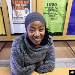 AIDS activist Vuyiseka Dubula sits beneath t-shirts in the offices of the Treatment Action Campaign in Cape Town's Khayelitsha township May 31, 2011