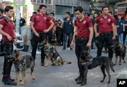 Police with dogs follow Turkey's lesbian, gay, bisexual, trans and intersex activists as they march despite a ban, in Istanbul, July 1, 2018.