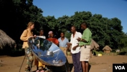 Menzies [far left] shows one of his solar cookers to villagers in Zambia (Photo: Sunfire)