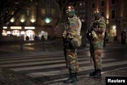 Belgian soldiers patrol in central Brussels as police searched the area during a continued high level of security following the recent deadly Paris attacks, Belgium, Nov. 23, 2015.