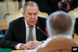 Russian Foreign Minister Sergey Lavrov listens to U.S. Secretary of State Rex Tillerson, right back to the camera, during their talks in Moscow, Russia, April 12, 2017.