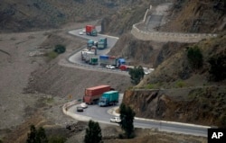Trucks carry goods on its way to neighboring Afghanistan through the Khyber Pass in Pakistani tribal area, March 21, 2017.