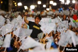 A supporter of Democratic Progressive Party (DPP) Chairperson and presidential candidate Tsai Ing-wen celebrates to preliminary results at their party headquarters in Taipei, Taiwan, Jan. 16, 2016.