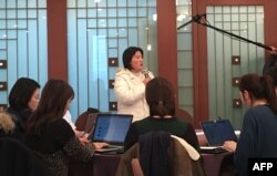 North Korean defector Kim Ryon-Hui (C) speaks to reporters during a press conference by Tomas Ojea Quintana, the UN's Special Rapporteur on human rights in North Korea, in Seoul on Dec, 14, 2017.