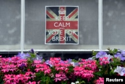 A vote 'Leave' poster is seen in a window in Chelsea, London, June 23, 2016.