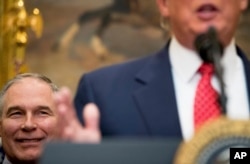 FILE - EPA administrator Scott Pruitt listens as President Donald Trump speaks before signing the Waters of the United States executive order, Feb. 28, 2017, in the Roosevelt Room of the White House.