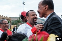 Ethiopia’s Prime Minister Abiy Ahmed, center, welcomes Eritrea’s President Isaias Afwerki upon his arrival at the airport in Gondar, for a visit in Ethiopia, Nov. 9, 2018. A recent rapprochement between the two countries is seen as having contributed to the lifting of sanctions against Eritrea.