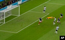 FILE - France's Kylian Mbappe, left, celebrates after scoring his side's fourth goal during the round of 16 match between France and Argentina, at the 2018 soccer World Cup at the Kazan Arena in Kazan, Russia, June 30, 2018.