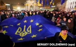 UKRAINE --A file picture made available 22 November 2014 shows Ukrainians waving an EU flag during a protest on Maidan Square, or Independence Square, in downtown Kyiv, Ukraine, 22 November 2013