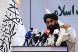 FILE - Taliban chief spokesman Zabihullah Mujahid speaks during an event in Kabul, Afghanistan, Nov. 25, 2021.