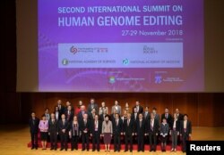 Hong Kong Executive Carrie Lam (C) and guests pose for a group photo during the International Summit on Human Genome Editing in Hong Kong, Nov. 27, 2018. (Zhang Wei/CNS via Reuters)