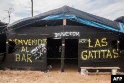 FILE - A brothel is seen in the illegal gold mining area of La Pampa, next to the interoceanic highway between Peru and Brazil, in the Madre de Dios southern Peruvian jungle, July 14, 2015.