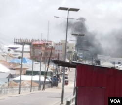 Smoke is seen rising above the scene of the compound of Somalia’s interior and security ministries, following a deadly attack by al-Shabab, July 7, 2018. (VOA/A. Abdulle)