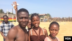 Derrick Tamba is seen with friends at a beach in Mamba Point, Monrovia, March 16, 2015. (Benno Muchler/VOA)