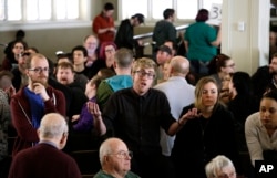 FILE - A man speaks in support of a candidate during a Democratic caucus in Seattle, March 26, 2016. Bernie Sanders won 74 of Washington state's delegates, while Hillary Clinton won 27.