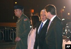 U.S. Vice President Mike Pence, second right, and his wife Karen are escorted to a waiting helicopter by the U.S. Ambassador to Japan William Hagerty, right in Fussa, Japan, Nov. 12, 2018.