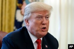 FILE - President Donald Trump speaks with reporters in the Oval Office of the White House in Washington, Dec. 22, 2017.