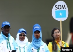 Mohamed Daud Mohamed, left, and Maryam Nuh Muse, second from right, are pictured with another member of their contingent during team-welcoming ceremonies for the 2016 Rio Olympics in Rio de Janeiro, Brazil, Aug. 4, 2016.