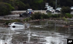 This photo provided by the Santa Barbara County Fire Department shows the U.S. Highway 101 at the Olive Mill Road overpass flooded with runoff water from Montecito Creek in Montecito, Calif., Jan. 9, 2018.