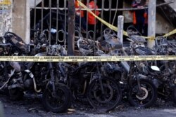 Sepeda motor terbakar akibat ledakan bom di salah satu gereja di Surabaya.