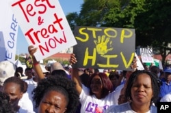 FILE - Activists march in Durban, South Africa, July 18, 2016, at the start of the 21st World Aids Conference.