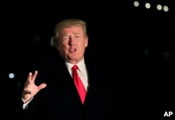 President Donald Trump speaks to reporters upon arrival at the White House in Washington, Jan. 26, 2018, from the World Economic Forum in Davos, Switzerland.