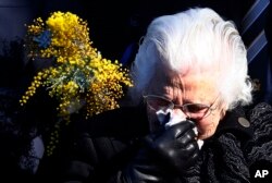 A relative of the Australian victims of Malaysia Airlines Flight MH17 reacts during a service for the unveiling of a memorial outside Parliament House in Canberra, Australia, July 17, 2015.