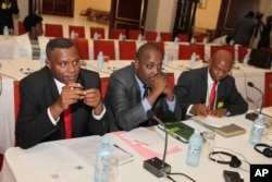 FILE - Burundi opposition members sit during peace talks at Entebbe State House, east of Uganda's capital Kampala, Dec. 28, 2015.