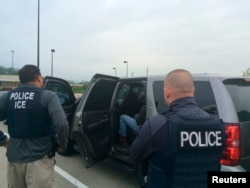 FILE - Officers from U.S. Immigration and Customs Enforcement's Enforcement and Removal Operations unit are shown during an operation targeting criminal aliens and other immigration violators in Philadelphia, in this image released May 11, 2016.