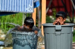 FILE - Rohingya refugees from Myanmar bathe at a makeshift camp in Lhokseumawe, Indonesia's Aceh province, Jan. 13, 2022.
