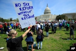 Protesters gather on Capitol Hill in Washington during a Tax Day demonstration calling on President Donald Trump to release his tax returns, April 15, 2017.