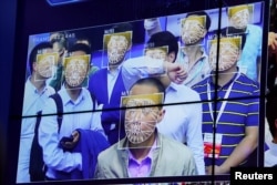 Visitors experience facial recognition technology at Face++ booth during the China Public Security Expo in Shenzhen, China, Oct. 30, 2017.