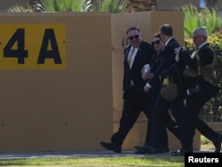 FILE - U.S. Secretary of State Mike Pompeo and his wife, Susan, walk at the U.S. Embassy compound in Baghdad, Jan. 9, 2019. The U.S. has ordered all non-essential personnel to leave the Iraq embassy.
