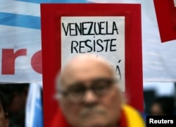 A sign that reads "Venezuela, resist" is seen behind former Argentine leftist guerrilla leader Roberto Perdia during a protest in support of Venezuela's government in Buenos Aires, Argentina, Aug. 17, 2017.