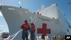 The USNS Mercy, a Navy hospital ship, is seen docked at Naval Base San Diego, March 18, 2020.