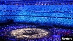 The Olympic Stadium is lighted up as athletes take part in the athletes' parade during the closing ceremony, Aug. 8, 2021. 