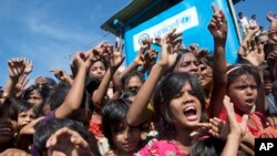 FILE - Rohingya refugee children shout slogans during a protest against the repatriation process at Unchiprang refugee camp near Cox's Bazar, in Bangladesh, Nov. 15, 2018.