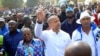 Democratic Republic of Congo's opposition presidential candidate Moise Katumbi (C) waves to his supporters as he walks to the prosecutor's office over government allegations he hired mercenaries in a plot against the state, in Lubumbashi, the capital of Katanga province of the Democratic Republic of Congo, May 9, 2016.