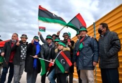 Libyans mark the 10th anniversary of their 2011 uprising that led to the overthrow and killing of longtime ruler Moammar Gadhafi, in Benghazi, Libya.