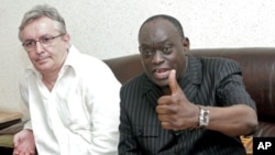 The lawyers of the deposed leader of Chad Hissene Habre, French Francois Serres (L), Senegalese El Hadj Diouf (R) hold a press conference. Senegal has suspended its plan to send Chad's former dictator Hissene Habre back to his own country, July 10, 2011