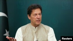 FILE - Pakistan's Prime Minister Imran Khan gestures during an interview with Reuters, in Islamabad